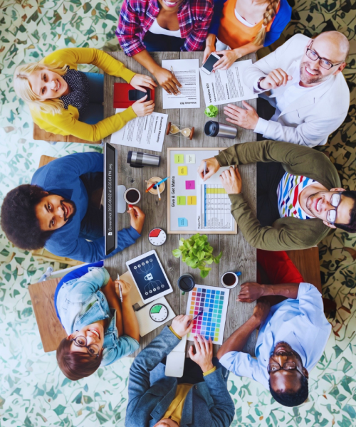 professionals seated around a table looking up